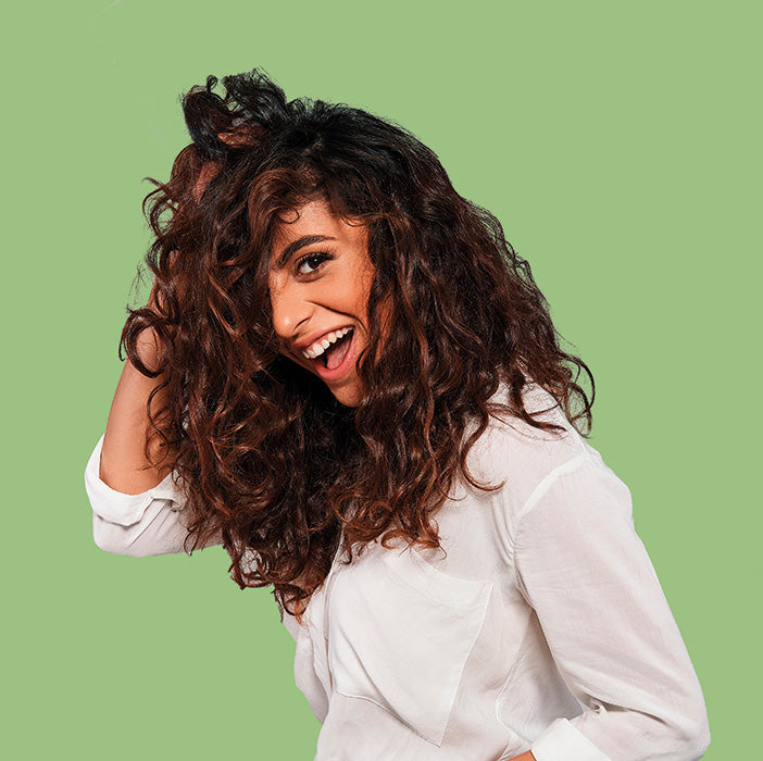 a woman with long curly hair