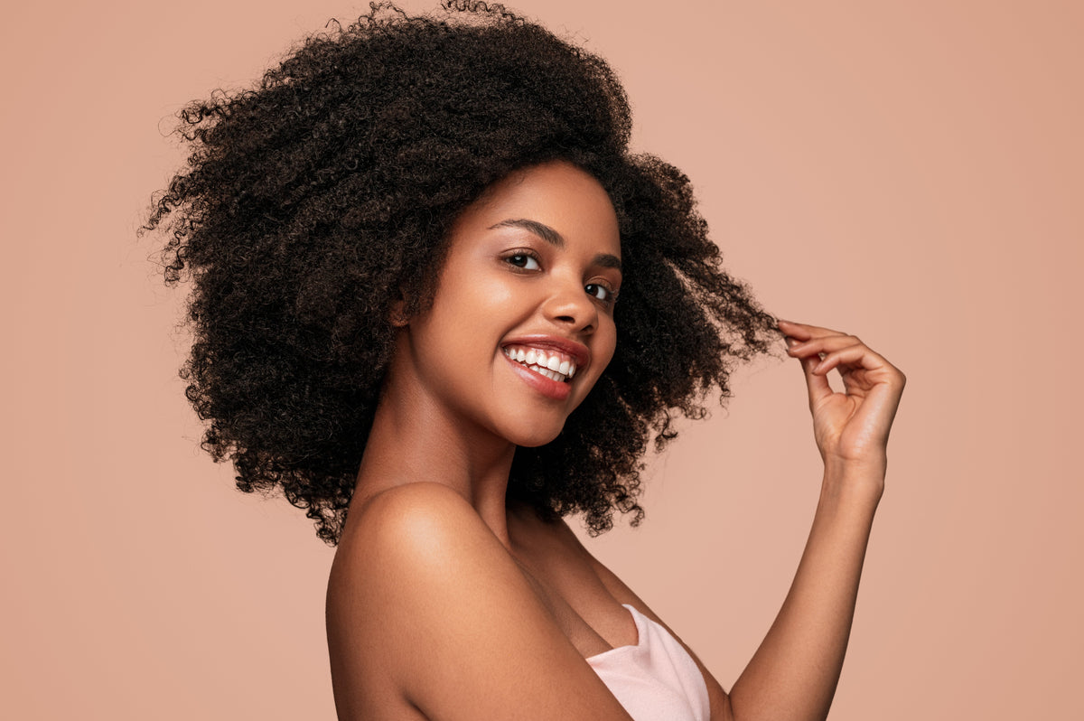 a woman with curly hair smiling