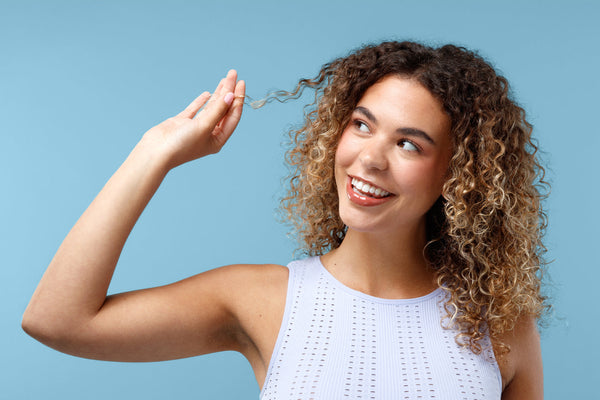 Woman with curly hair on a light blue background