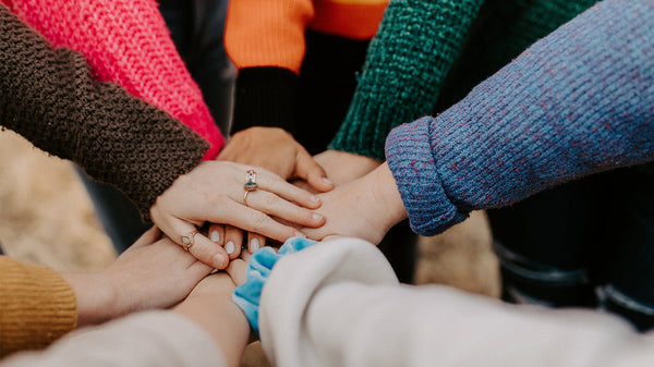 Multiple hands stacked on top of each other