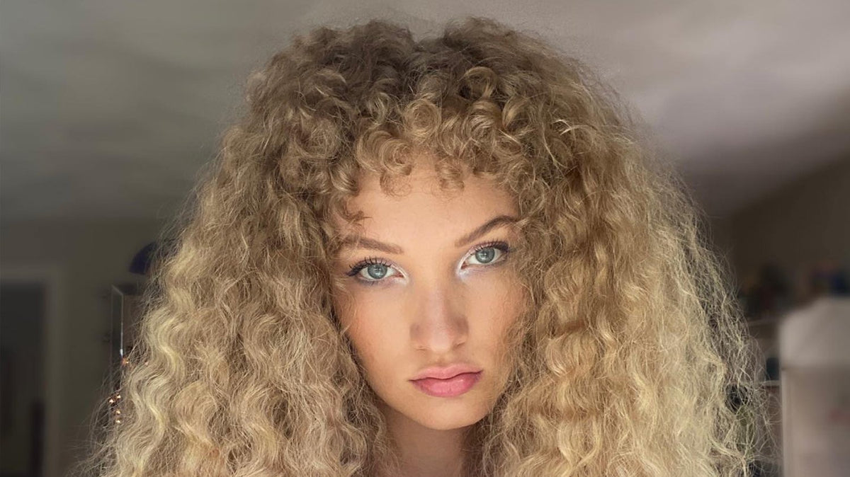 a woman with curly blonde hair