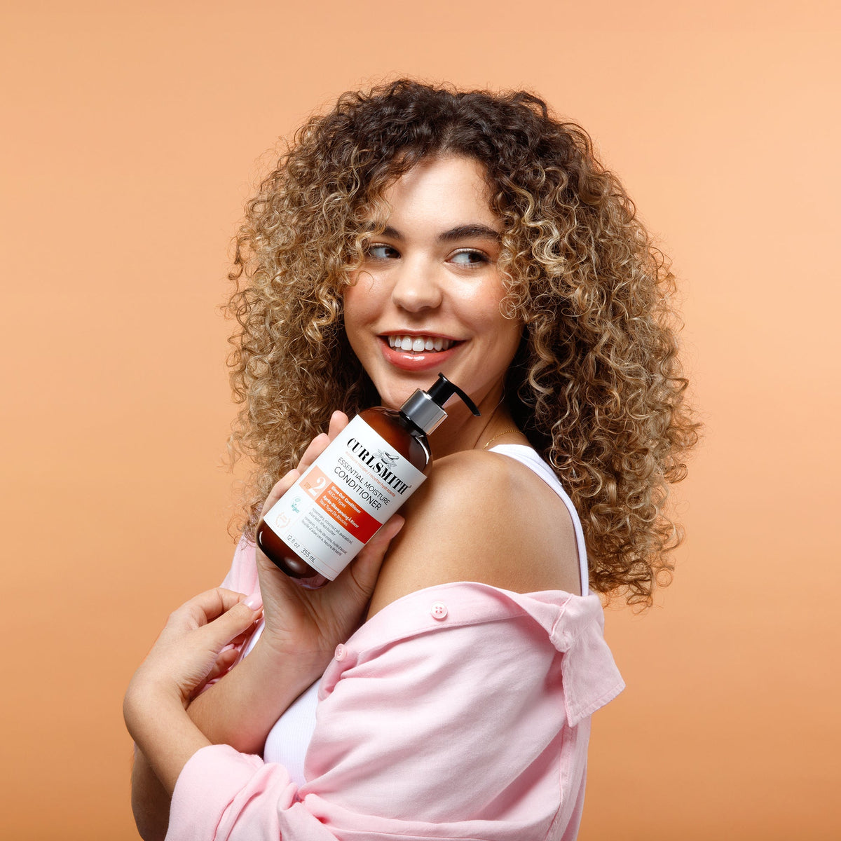 a woman holding a bottle of liquid