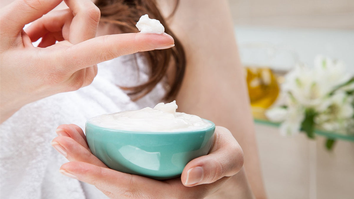 a person holding a bowl of cream