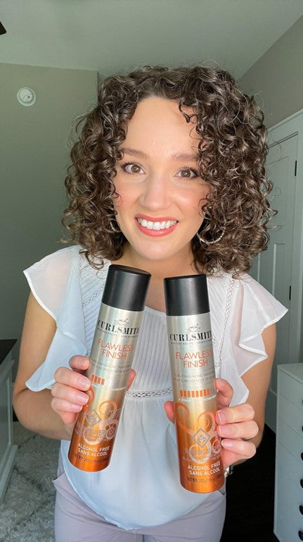 a woman holding two bottles of hair