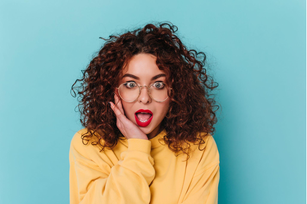 a woman with her mouth open and glasses