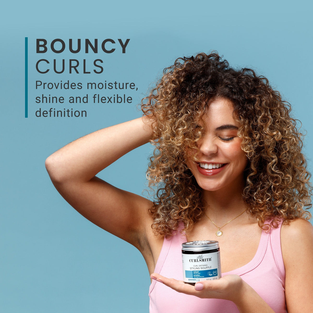 Woman with curly hair holding a product container against a blue background, with text about bouncy curls.