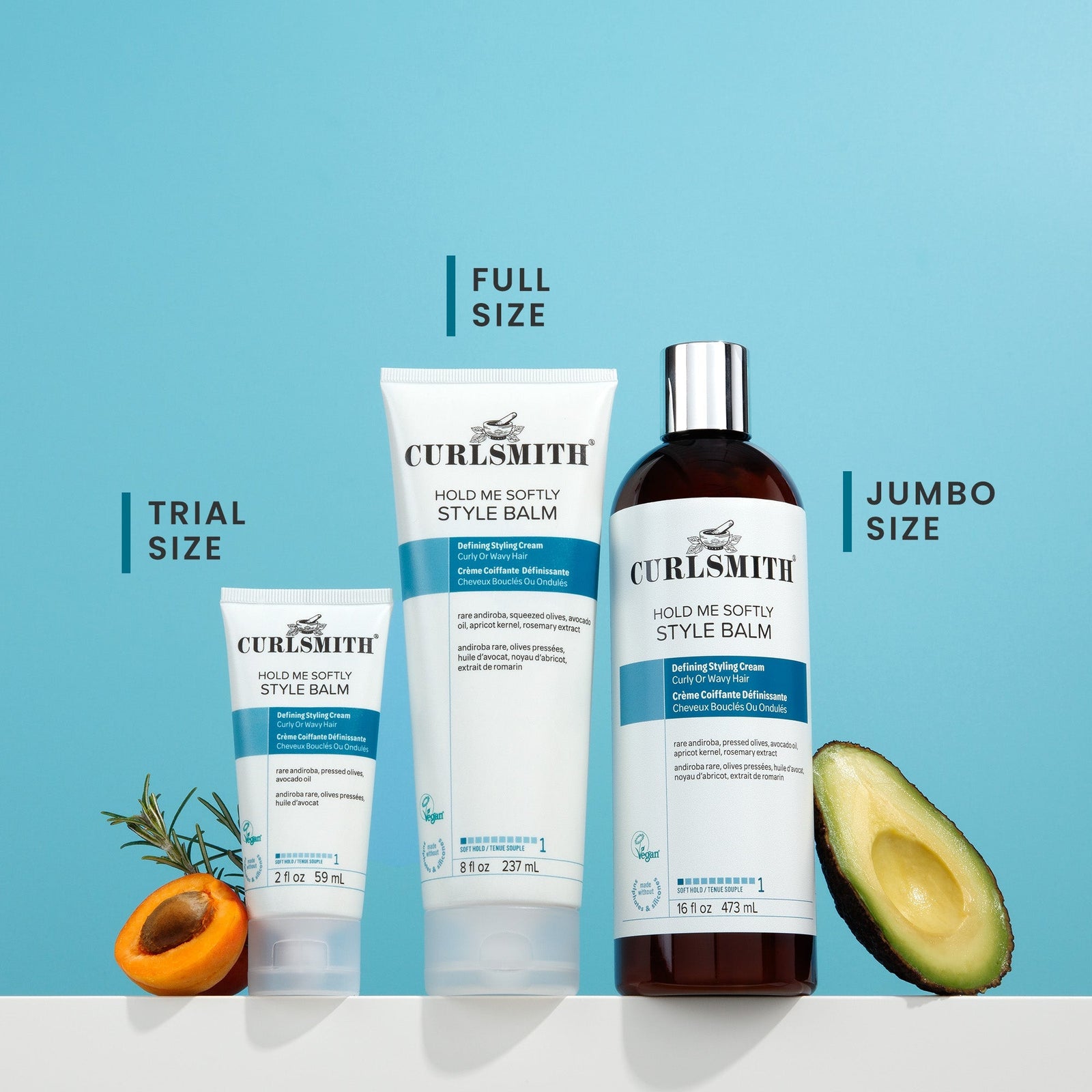 Curlsmith products including a bottle and tubes on a blue background with avocado and apricot slices.