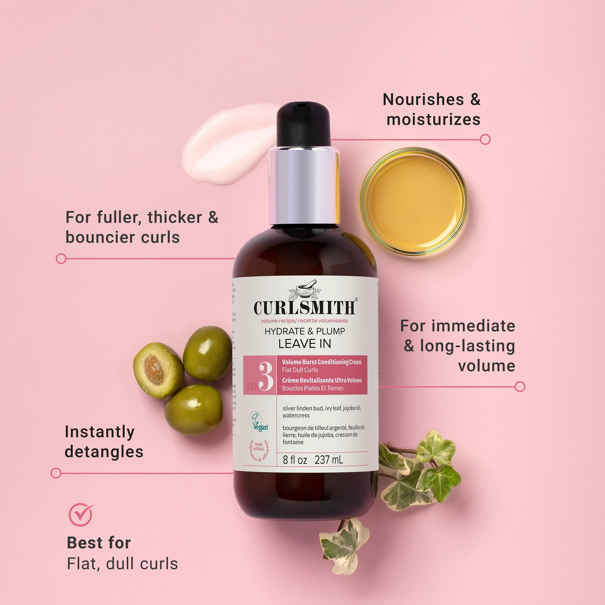 Curlsmith leave-in conditioner bottle with olive oil and leaves on a pink background