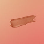 Nude-colored makeup swatch on a matching pink background